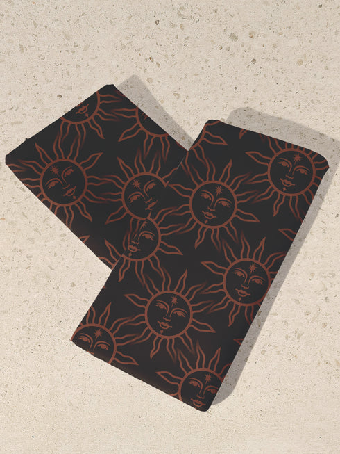 Elegant black cloth napkins with a deep red celestial sun motif, crafted from polyester in a four-piece set, designed for sophisticated dining.
